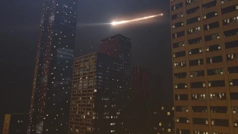 Glowing meteors or space junk Burning behind skyscrapers. Stock Footage 247873444