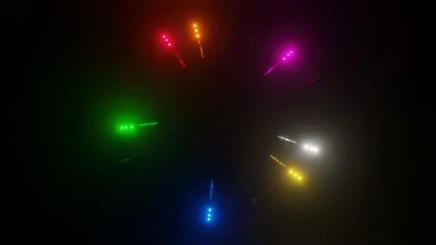 Glowing multi-colored spheres fly in a circle through the rings on a black backg Stock Footage 163868474