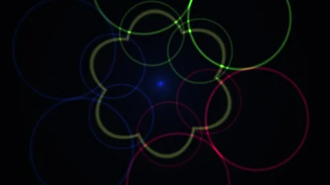 Glowing neon circles overlapping in dark background forming flower patterns. Vidéo 335563690