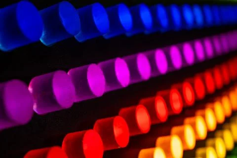 Glowing Neon Cylinders in Gradient Rainbow Colors Stock Photos