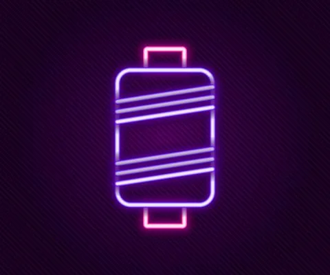 Glowing neon line Sewing thread on spool icon isolated on black background. Yarn Illustrazione stock