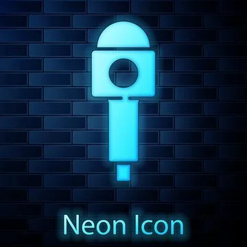 Glowing neon Microphone icon isolated on brick wall background. On air radio  Illustrazione stock