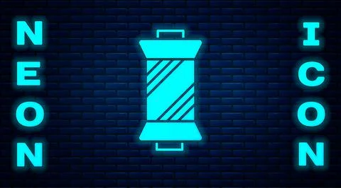 Glowing neon Sewing thread on spool icon isolated on brick wall background. Yarn Stock Illustration