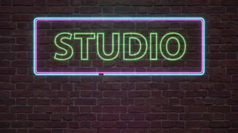 Glowing Neon Studio Sign with Flickering Effect on Urban Brick Wall Stock Footage 341906907