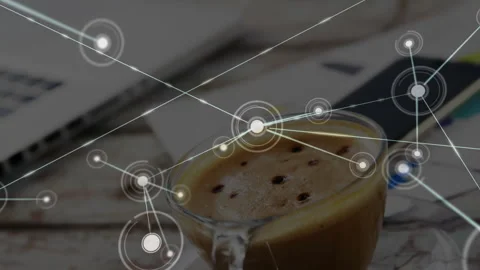 Glowing node emerging above coffee cup spreading network lines across desk Stock-Footage 314707323
