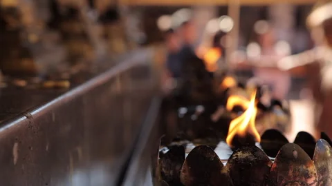 Glowing Oil Lamp Casting Light on a Sacred Image in Thai Temple Stock-Footage 333705197