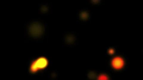 Glowing orange and red light particles drifting in dark space Vídeos de archivo 336796784