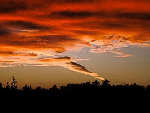 Glowing orange clouds during a sunset Stock Photos