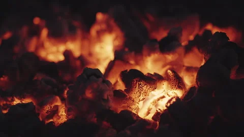 Glowing orange flames consuming charcoal pieces, generating intense heat an.. Stock Footage 300798302