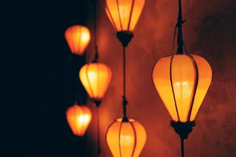 Glowing orange lanterns creating warm decorative background, Vertical hanging Stock Photos