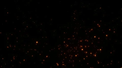 Glowing orange particles floating through dark space with soft cinematic ember Vidéo 334568223