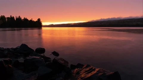 Glowing Orange Rainy Sunset Over a Remote Lake Stock Footage 169712716