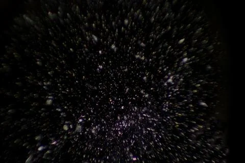 Glowing particles are floating across dark void in flat vector design, creating Illustrazione stock