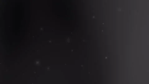 Glowing particles float on black gray background Video stock 297686716