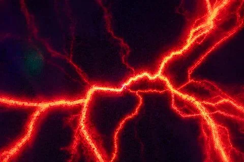 Glowing plasma filaments create a mesmerizing display of red and orange light Stock Photos