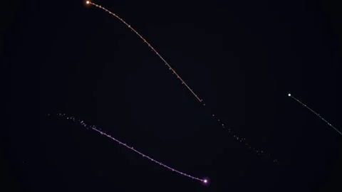 Glowing points and trails against a dark background Video stock 331644977