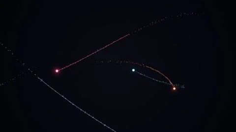 Glowing points and trails against a dark night sky 스톡 동영상 331644979