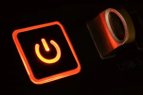 Glowing power button with usb flash on black background 스톡 사진