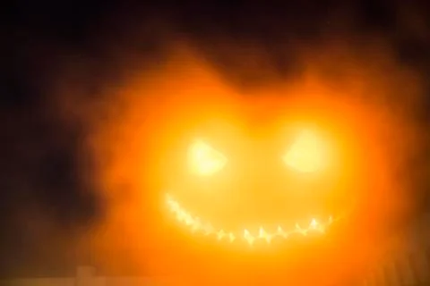 Glowing Pumpkin Jack-O-Lantern in Foggy Night Stock Photos