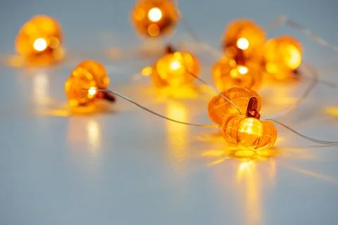 Glowing pumpkin string lights decorating for autumn halloween Stock Photos