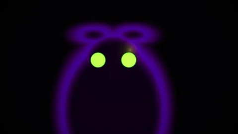 Glowing purple jack o lantern with green eyes on black background. Stock Footage 337513571