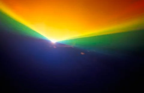 A glowing rainbow pattern of laser lights against a black background Stock Photos