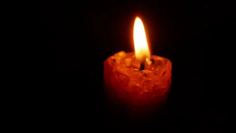 Glowing red candle with flickering flames arranged in a grid pattern against a Stock Footage 317554299