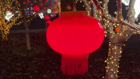 Glowing red Chinese lantern, festive night scene in urban setting Stock Footage 331486752