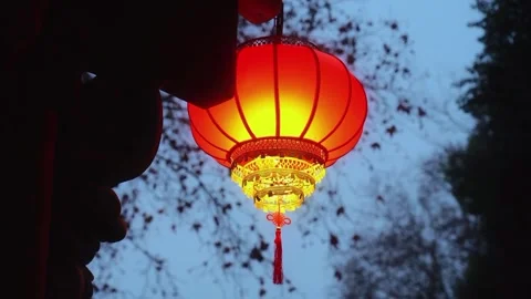 Glowing Red Chinese Lantern Hanging at Dusk Traditional Festival Light Stock-Footage 329616174