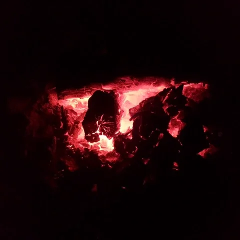 Glowing red embers and burned firewood inside fireplace. Stock Footage 346223795