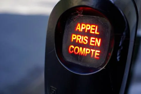 Glowing red emergency button display with French text Appel pris en compte 写真素材
