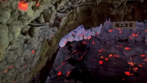 Glowing Red Lava-Like Lights Inside a Dark Japanese Cave Stock Footage 345371636