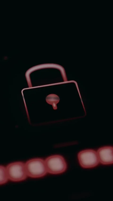 Glowing red padlock against a black background, security and data privacy 스톡 동영상 331573427