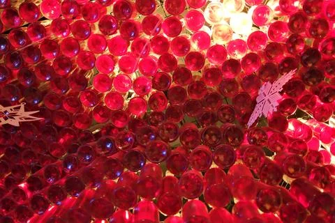 Glowing red wine bottle ceiling installation Stock Photos