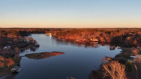 Glowing Reddish-Gold Trees at Sunset Lake Shadowood Drone Stock Footage 327802217