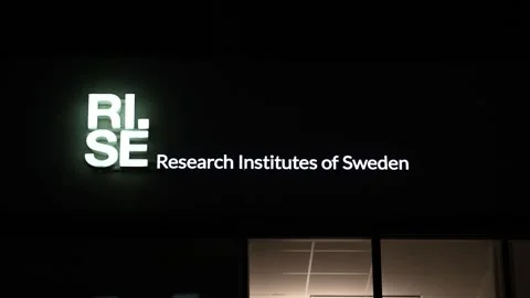 Glowing RISE logo on a building at night Stock Footage 334962269