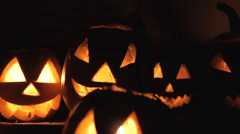 Glowing scary pumpkins at night on the steps Stock Footage