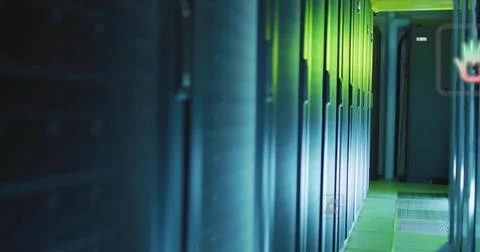 Glowing server cabinets reflecting blue LEDs in data center aisle, revealing Stock Photos