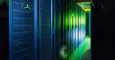 Glowing server racks receding down narrow data center aisle, showing cable trays Stock Photos