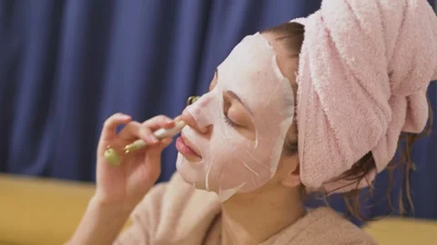 Glowing Skin Routine: 27 Year Old Blonde European Woman with Facial Mask Stock Footage 306655556
