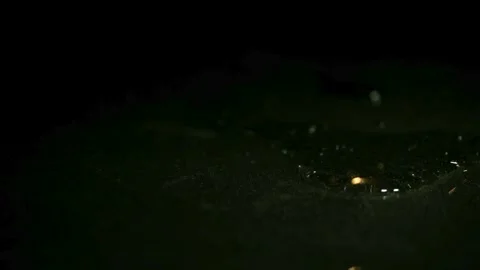 Glowing sparks fall on dark wet surface Stock Footage 326754776