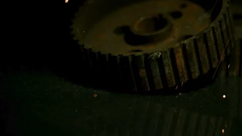 Glowing sparks falling onto a rusty old metal gear Stock Footage 327631847
