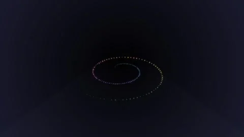 A glowing spiral of small lights set against a dark void background Video stock 335117717