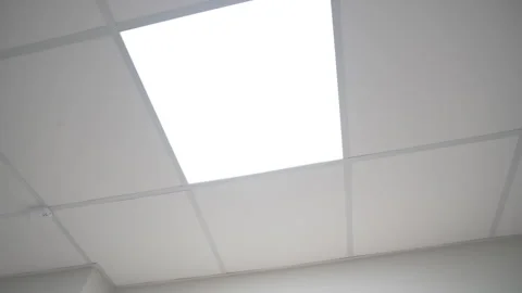 Glowing square led lamp on suspended ceiling in office Видео 313830442