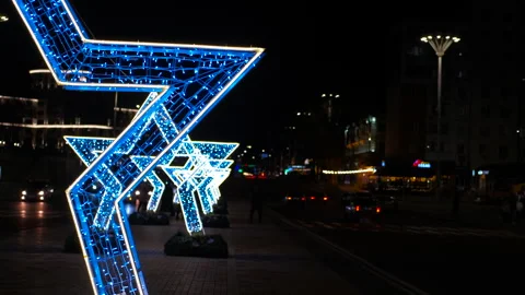 Glowing star decorations creating festive atmosphere in city at night Stock Footage 316068461