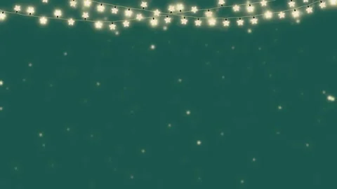 Glowing star shaped string lights hanging against deep teal background with 库存影片 345138100