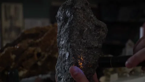 Glowing stone. Opal. The stone glows under ultraviolet light. Geology. Stock Footage 266277296