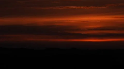 Glowing sun on horizon during vibrant sunset with orange sky Cedar Key Florida Stock Footage 333485252