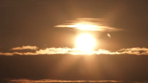 Glowing Sun Reveal Behind Cloud Layer Time Lapse 動画素材 112624028