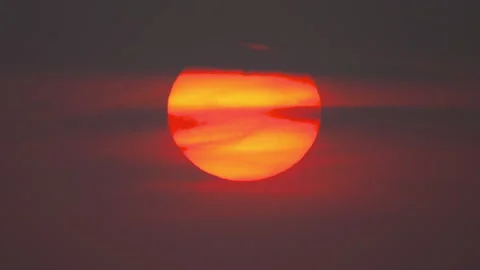 Glowing sun at sunset with an orange sky Video stock 284020871